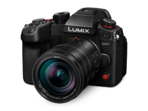 A black Panasonic Lumix GH7 mirrorless camera body shown with a mounted zoom lens, angled slightly to the right against a plain white background.