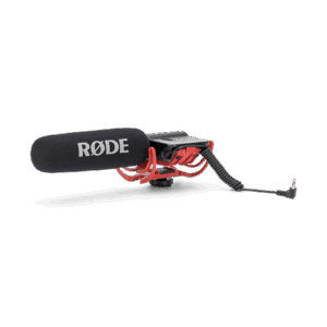 The original Røde VideoMic shotgun microphone with its integrated black rubber band suspension shock mount, attached to a camera hot-shoe base with a coiled audio cable.