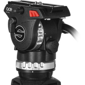 A close-up view of a black Sachtler Ace fluid tripod head featuring prominent red tension control dials and a black pan bar extending out to the left.