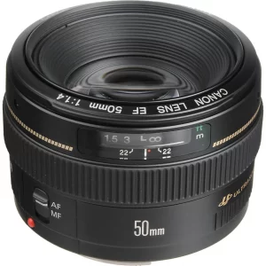 Front perspective view of a Canon EF 50mm lens showing its front glass element, focal length markings, and textured plastic body.