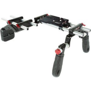 A professional black SHAPE shoulder rig camera support system with dual quick-handle handgrips, adjustable 15mm rods, and a padded shoulder mount.