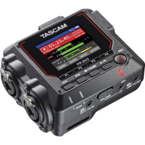 A top-down, angled view of a compact black TASCAM FR-AV2 field recorder featuring a small, bright color display screen showing audio levels, surrounded by red accent trim on its sides.